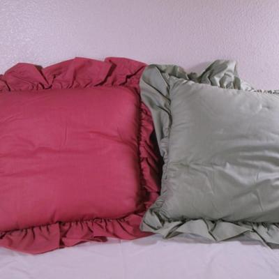 2 decorative ruffled pillows
