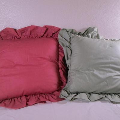 2 decorative ruffled pillows