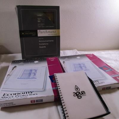 1 box parchment resume paper, 2 boxes of sheet protectors, notebook