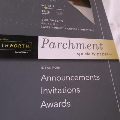 1 box parchment resume paper, 2 boxes of sheet protectors, notebook