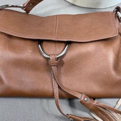 Sale Photo Thumbnail #138: Soft brown leather with tassels and silver tone hardware. 13” by 8.5” in very good condition.