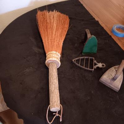 2 VINTAGE CAST IRONS AND A HANDCRAFTED BROOM