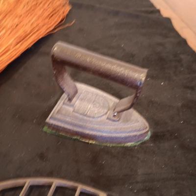 2 VINTAGE CAST IRONS AND A HANDCRAFTED BROOM