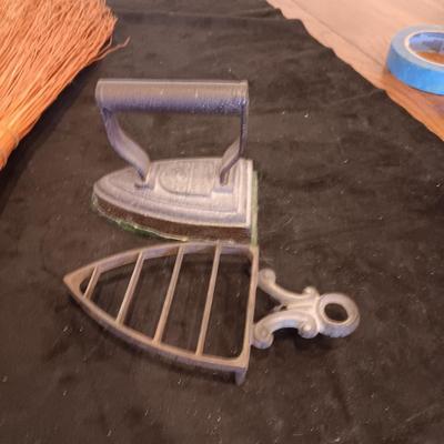 2 VINTAGE CAST IRONS AND A HANDCRAFTED BROOM