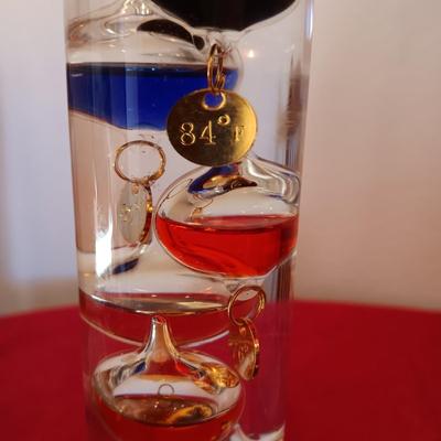 GALILEO THERMOMETER AND SEVERAL CANDLES