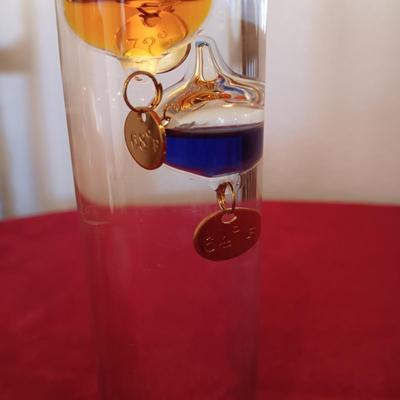 GALILEO THERMOMETER AND SEVERAL CANDLES
