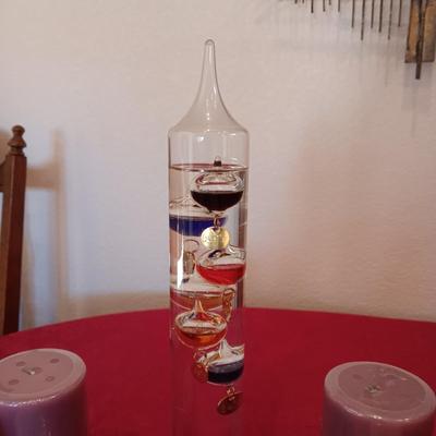 GALILEO THERMOMETER AND SEVERAL CANDLES