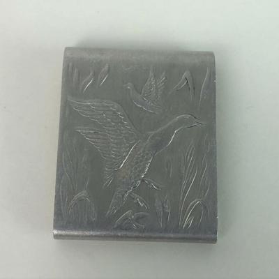 With an embossed hunting motif of ducks on the wing here is a vintage aluminum paper matchbook cover or matchsafe...2 1/8" by 1...
