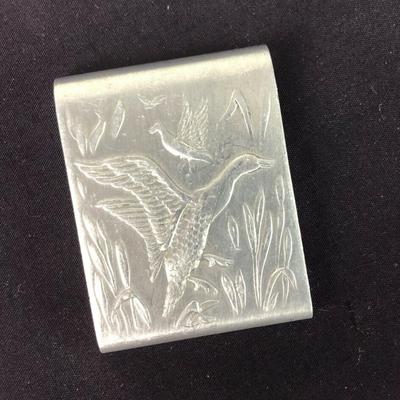 With an embossed hunting motif of ducks on the wing here is a vintage aluminum paper matchbook cover or matchsafe...2 1/8" by 1...