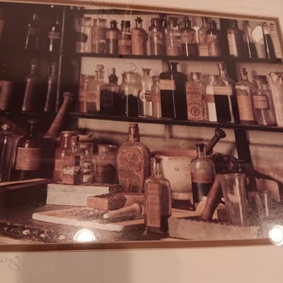 SIGNED "THE APOTHECARY" FRAMED PICTURE AND CONTAINERS PLUS AN APOTHECARY STORE MADE FROM A BRICK