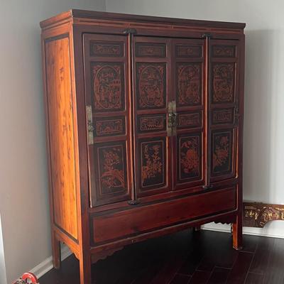 Sale Photo Thumbnail #6: 70"h x 55"l x 22"d
Chinese red and black carved and lacquered cabinet, decorated with garden scenes, flowers and birds, dating from the late 19th century. It's in excellent overall condition, and it also features an interior drawer and shelf with the orig