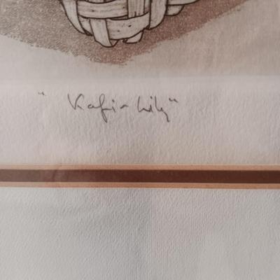 SIGNED AND NUMBERED PICTURE OF KAFFIR LILY AND A WICKER ARM CHAIR