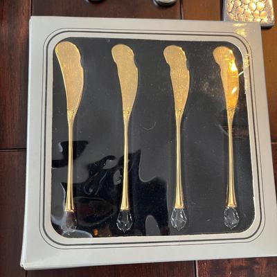 Lot of salad servers, cocktail skewers and cheese knives