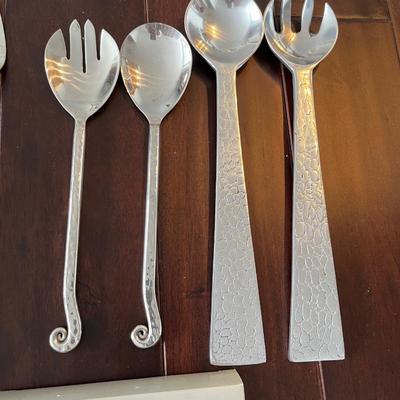 Lot of salad servers, cocktail skewers and cheese knives