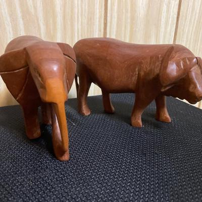 Wood carved elephant and water buffalo
