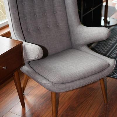 Sale Photo Thumbnail #55: a very eye-catching side chair. Natural teak legs. I believe this is sold by West Elm
The style is wing back. 
the upholstery is nice and clean. very good condition.
the cushion is attached.
Height: 38" Length: 25" in the front of the chair seat. Depth fr