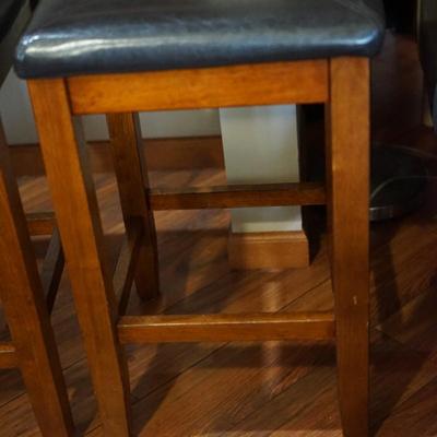 SET OF FOUR VERY HANDY SNACK BAR STOOLS W/ FAUX BLACK LEATHER UPHOLSTERED PADS. WOOD FRAME