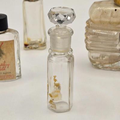 LOT 542: Antique Perfume Bottles, Talc Bottles, Ladies Handkerchiefs, Makeup , Greeting Cards, Face Cream, Face Fan, & Small Bud Vase