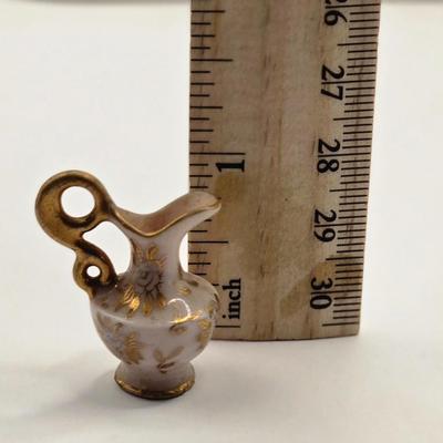 LOT 553: Miniatures of All Sorts, Including Musical Instrument Playing Monkeys, Salt & Pepper Shakers, Vase, Pitcher, & Kodak...