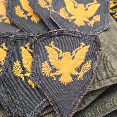 LOT 556: Army Jacket, Multiple Patches, Notice of Recruitment, Metal Pins, Cannon, & Charm, Postcard, & First Aid smelling Salts