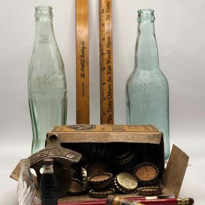 LOT 603: Have a Coke and a Smile; Vintage Coca Cola Rulers, Pencils, Bottles, Train Car Carrier, Bottle Opener, & Box of Ajax Bottlecaps