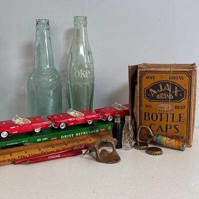 LOT 603: Have a Coke and a Smile; Vintage Coca Cola Rulers, Pencils, Bottles, Train Car Carrier, Bottle Opener, & Box of Ajax Bottlecaps