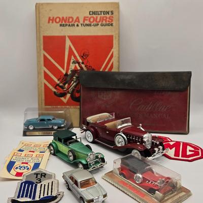 LOT 623: Honda Repair Guide Book, 1976 Cadillac Owner's Manuel, Various Die Cast Metal Cars, Morris Garages Car Logo Patches,...