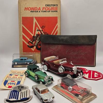 LOT 623: Honda Repair Guide Book, 1976 Cadillac Owner's Manuel, Various Die Cast Metal Cars, Morris Garages Car Logo Patches,...