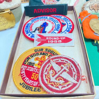 LOT 662: Collection of Vintage Boy Scout Memorabilia - Patches, Tokens, Hand Crafted Neckerchief Holders, Hat, Belt, Bandanas , Books and...