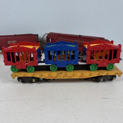 LOT 735: Red Locomotive & Tinder Car, American Flyer Circus Flat Cars with Cages & Truck/Tractors