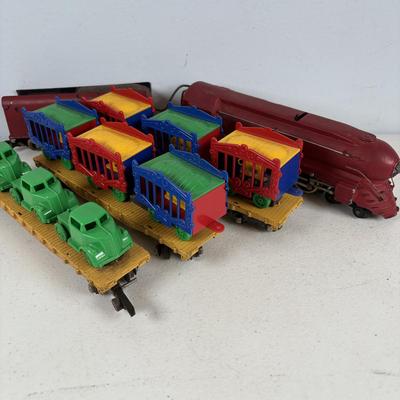 LOT 735: Red Locomotive & Tinder Car, American Flyer Circus Flat Cars with Cages & Truck/Tractors