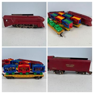 LOT 735: Red Locomotive & Tinder Car, American Flyer Circus Flat Cars with Cages & Truck/Tractors