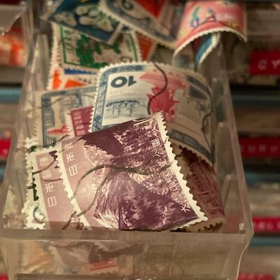Metal organizer with stamps from around the world