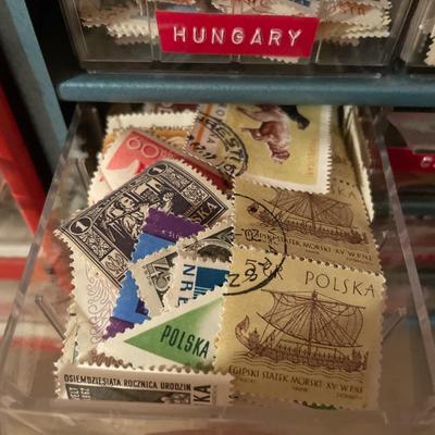Metal organizer with stamps from around the world