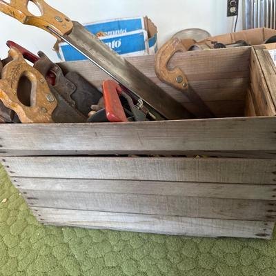 Wooden crate full of hand saw