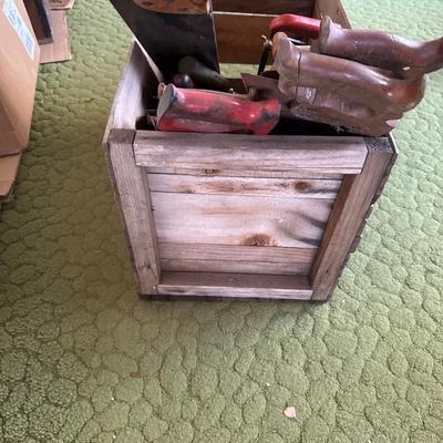 Wooden crate full of hand saw