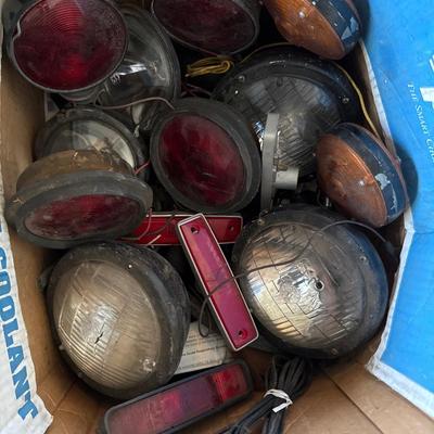 Box of vintage lights with spark plugs at the bottom of the box