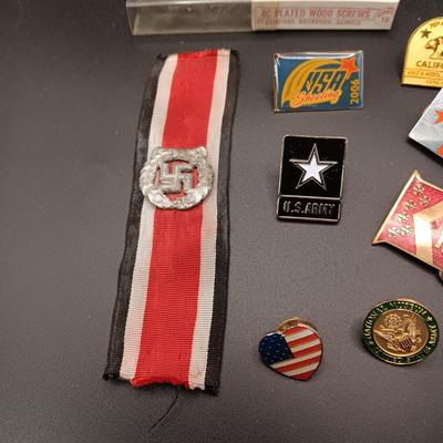 VARIOUS PINS INCLUDING A SWASTIKA AND SOME FIRED BULLETS??