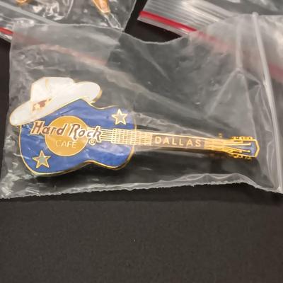 A VARIETY OF HARD ROCK CAFE PINS FROM VARIOUS PLACES
