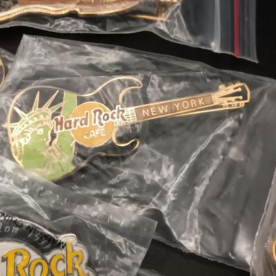 A VARIETY OF HARD ROCK CAFE PINS FROM VARIOUS PLACES