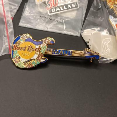 A VARIETY OF HARD ROCK CAFE PINS FROM VARIOUS PLACES