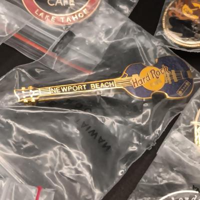 A VARIETY OF HARD ROCK CAFE PINS FROM VARIOUS PLACES