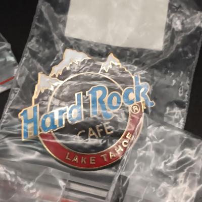 A VARIETY OF HARD ROCK CAFE PINS FROM VARIOUS PLACES