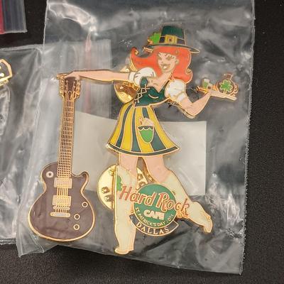 A VARIETY OF HARD ROCK CAFE PINS FROM VARIOUS PLACES