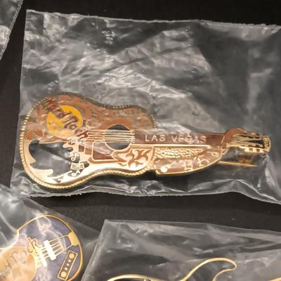 A VARIETY OF HARD ROCK CAFE PINS FROM VARIOUS PLACES