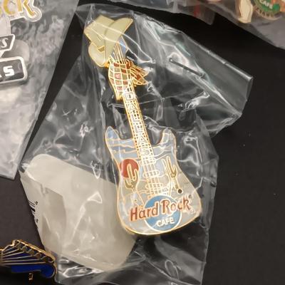 A VARIETY OF HARD ROCK CAFE PINS FROM VARIOUS PLACES