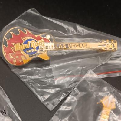 A VARIETY OF HARD ROCK CAFE PINS FROM VARIOUS PLACES