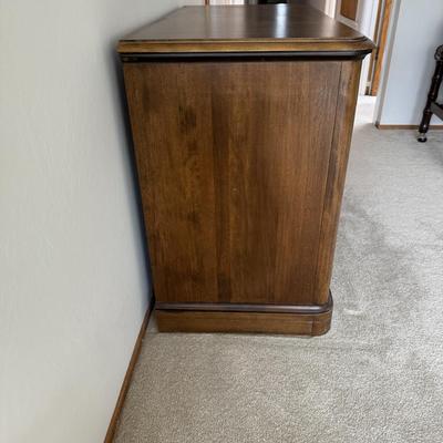 Sale Photo Thumbnail #48: The Temple Stuart bar cabinet is a vintage piece crafted from wood, featuring a classic brown finish. It stands 40 inches tall, 30 inches long, and 20 inches wide, with a rectangular shape. Designed for the living room, this free-standing cabinet includes