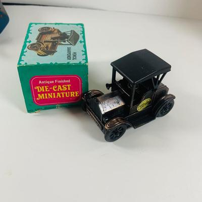 LOT 521:Vintage Collection Tin Toy Cars, Model T Plastic Salt and Pepper Shake Set, Pencil Shapener and Paperweight