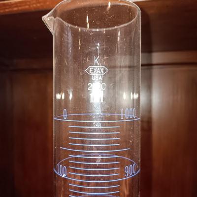NEEDLEPOINT PHARMACY PICTURE, TALL GLASS BEEKER AND BRASS PESTLE & MORTAR